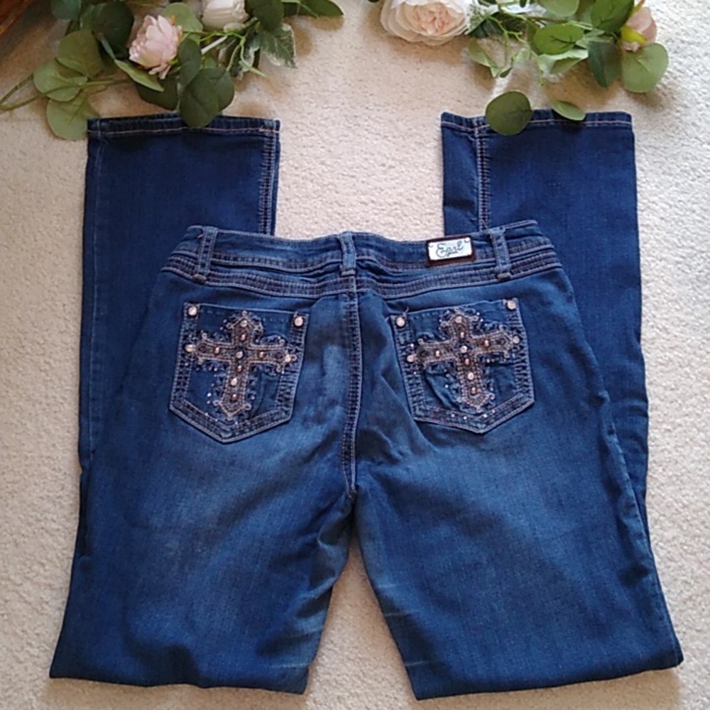 Boot cut jeans with extra rhinestones, hardware and stitching.